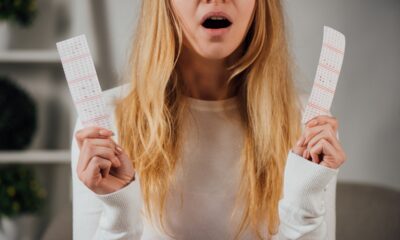 cropped-view-of-surprised-woman-holding-lottery-tickets