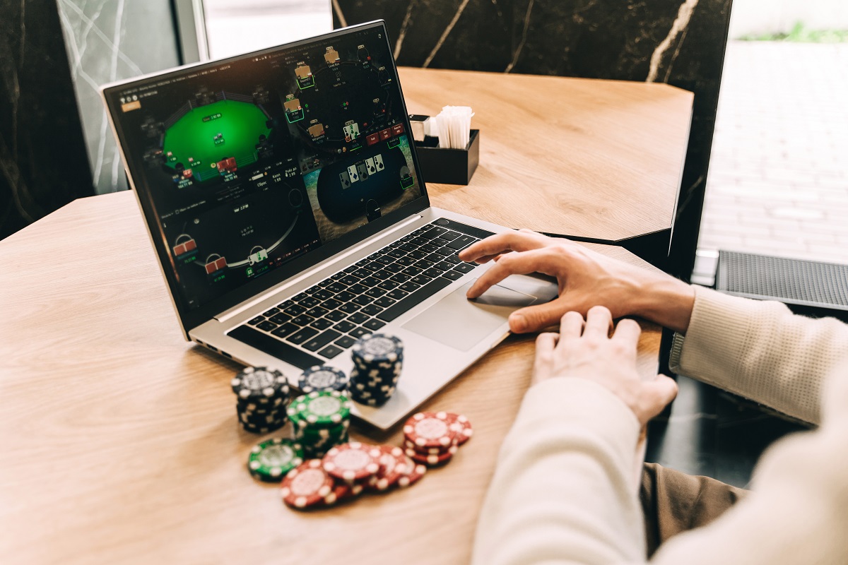 young-man-play-online-poker-in-laptop